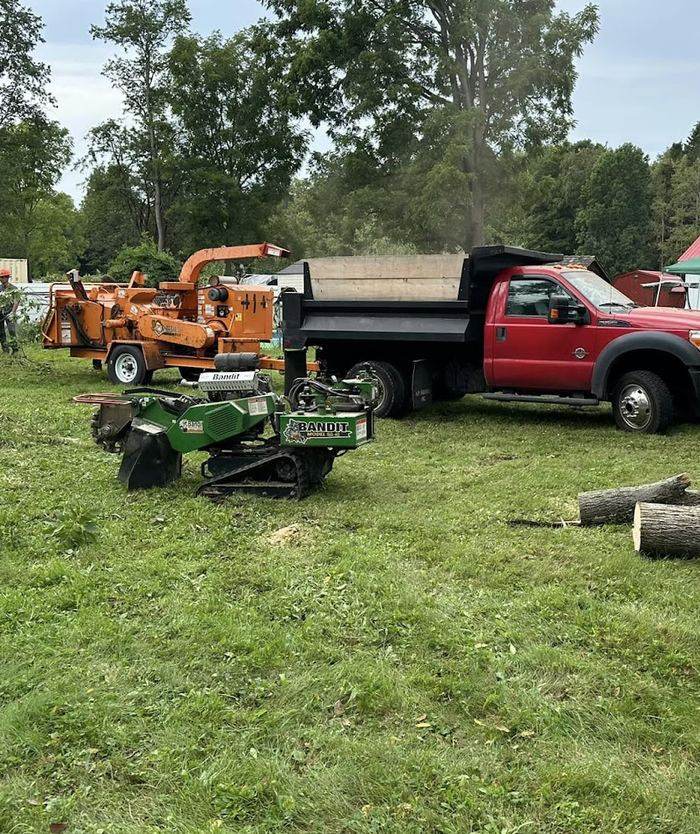 1776 Tree Service chipper, stump grinder and dump truck on a job